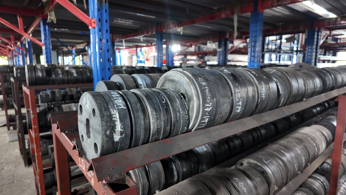Extrusion dies arranged on factory storage racks