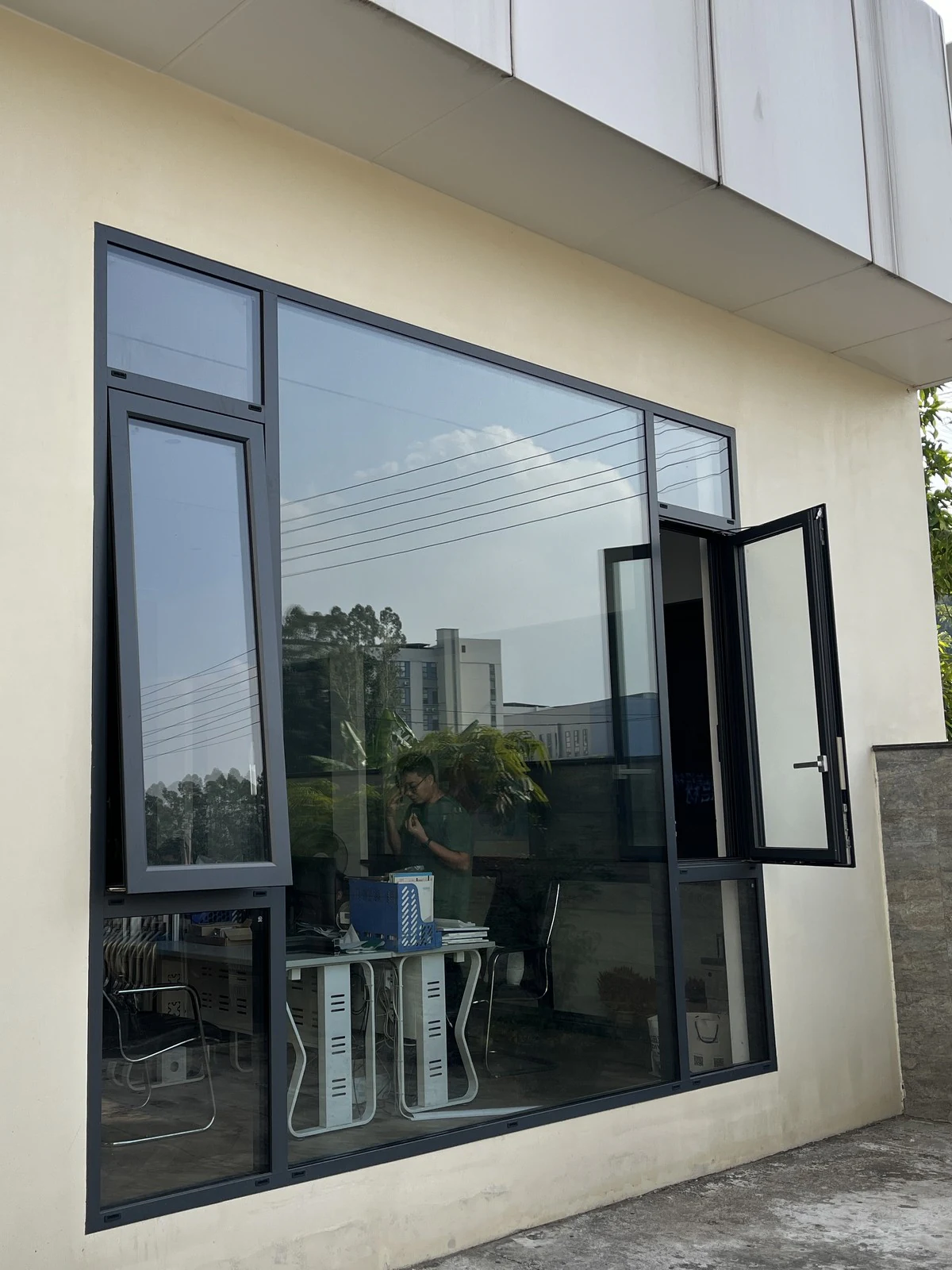 Dark-framed window with an open casement at the Guantian showroom